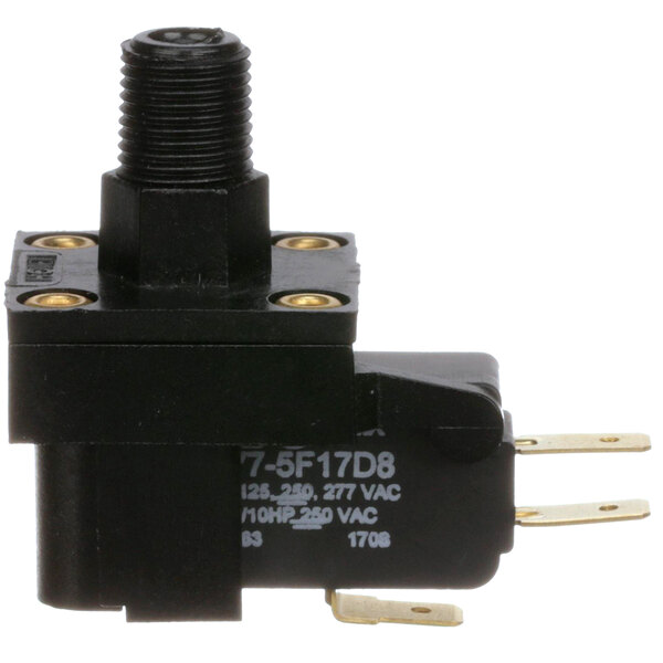 A black Groen pressure switch with gold screws and a black wire.