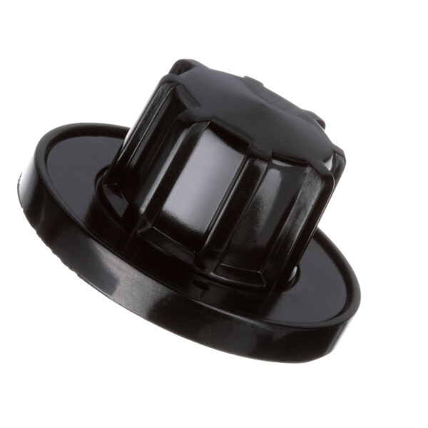 A close-up of a black plastic Garland range knob with a white background.