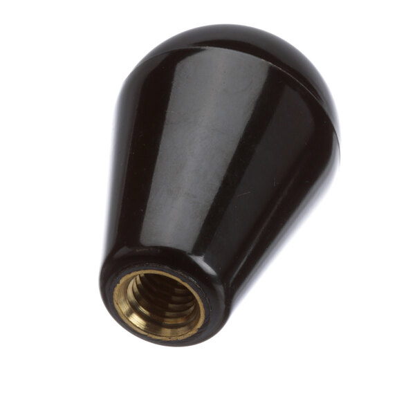 A black plastic Montague convection oven knob with a gold metal nut.