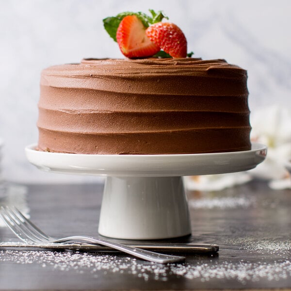 A chocolate cake on a 10 Strawberry Street Whittier white porcelain cake stand.