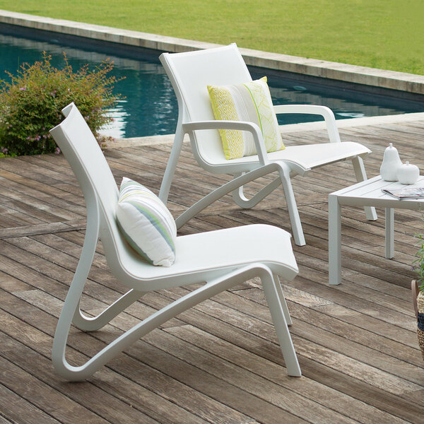 Grosfillex US001096 Sunset White / Glacier White Resin Outdoor Sling Lounge Chair - 4/Pack
