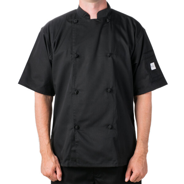 A man wearing a Mercer Culinary black chef coat.