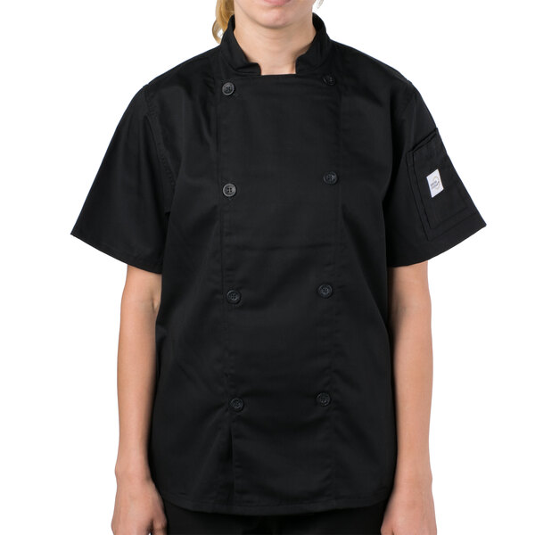 A woman wearing a black Mercer Culinary chef jacket.