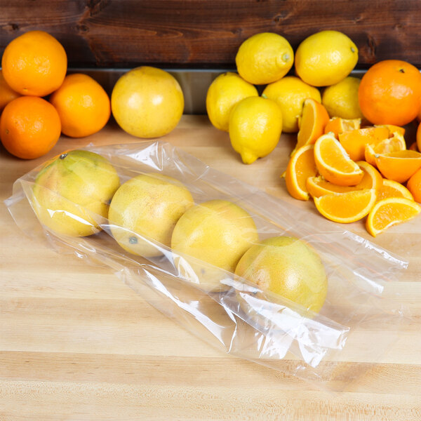 A plastic bag of oranges and lemons.