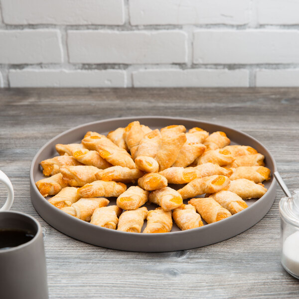 A 10 Strawberry Street gray stoneware tray with a plate of pastries and a mug of coffee on a table.