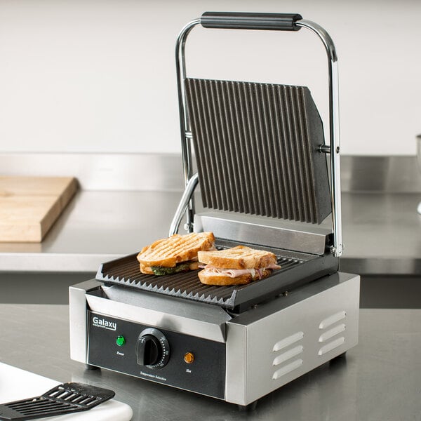 A sandwich on a Galaxy Panini Grill with grooved plates.
