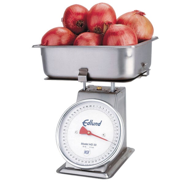 An Edlund produce scale with a bowl of red onions on it.