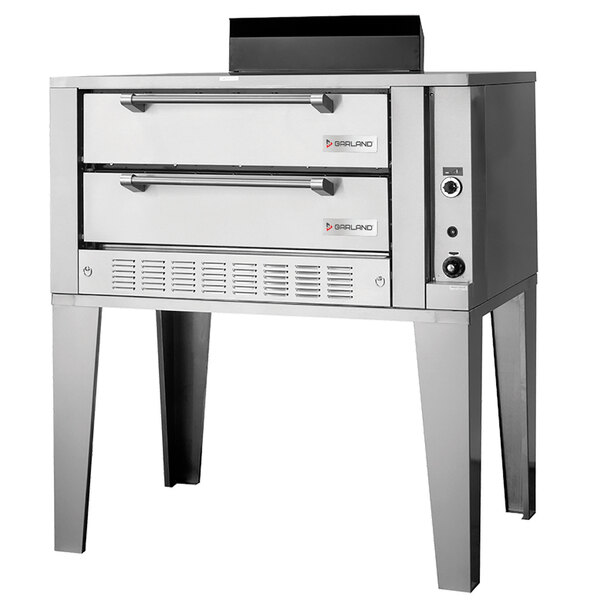 A silver stainless steel Garland Liquid Propane double deck pizza oven with two drawers.