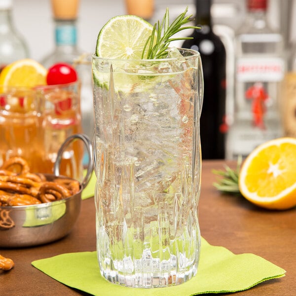 A Nachtmann Shu Fa longdrink glass of water with lime and rosemary on a table.
