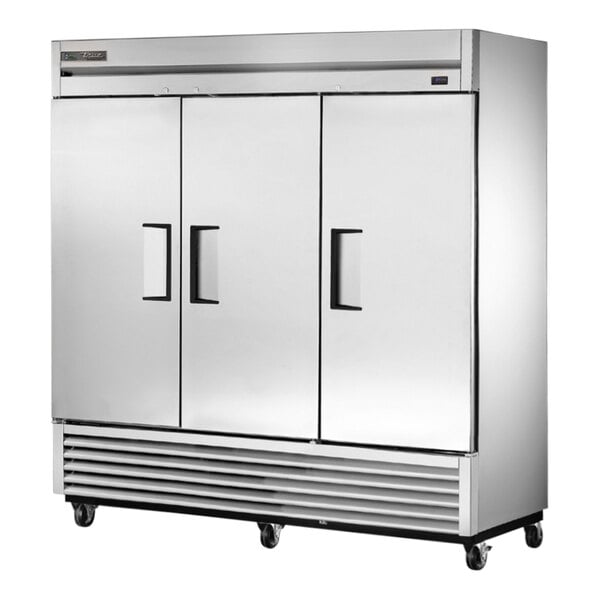 A large silver True reach-in refrigerator with two solid doors.
