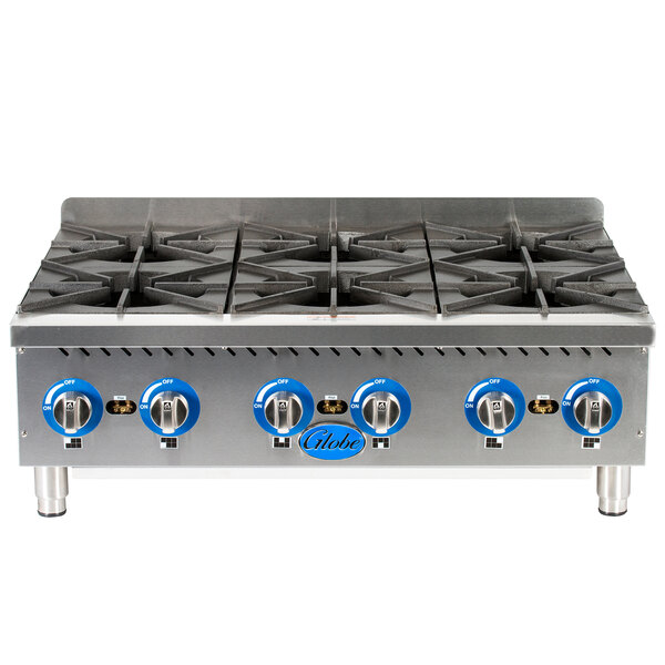 A stainless steel Globe countertop gas hot plate with four burners.