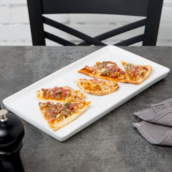 A white Libbey porcelain tray with four slices of pizza on it.