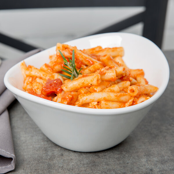 A Libbey Aluma White porcelain bowl filled with pasta and tomato sauce.