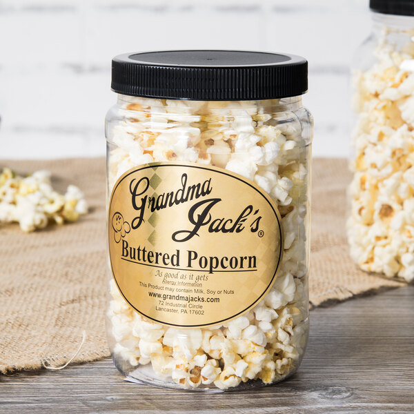 A jar of Grandma Jack's Gourmet Buttered Popcorn with a label.