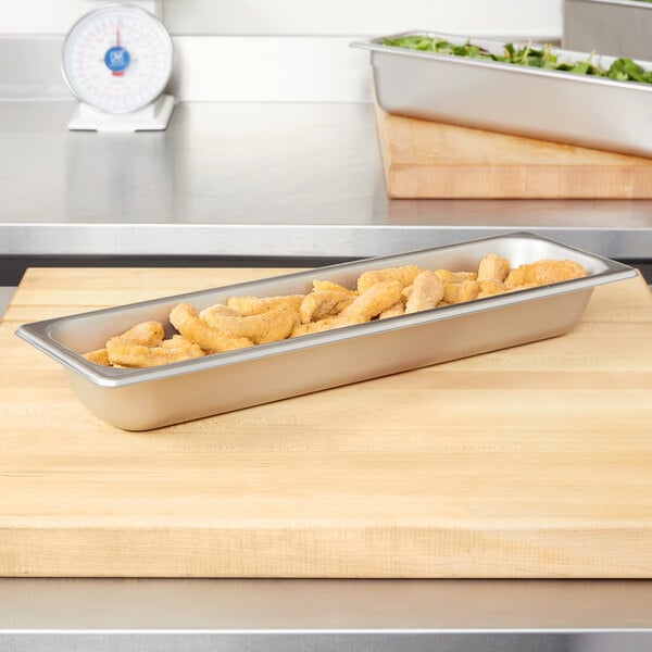 A Vollrath Super Pan with food on a table.