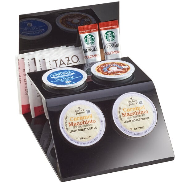 A black Cal-Mil coffee pod organizer with four slots holding different types of coffee.
