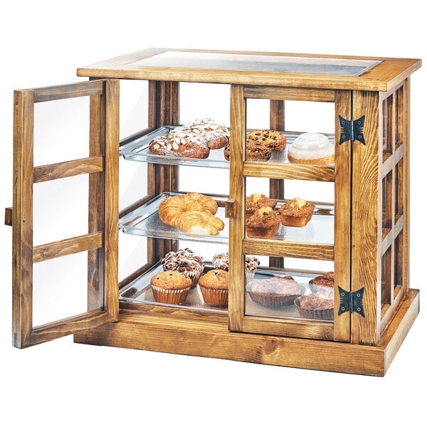 A Cal-Mil Madera rustic pine bakery display case with muffins on shelves.
