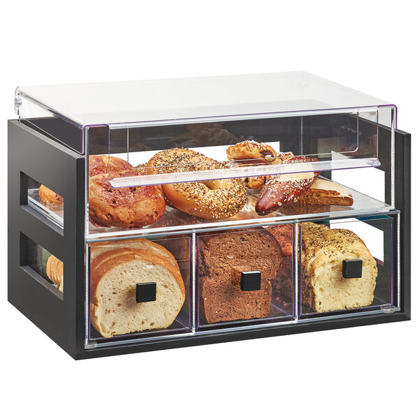 A black and clear 2 tier bread display case with bread and pastries inside.