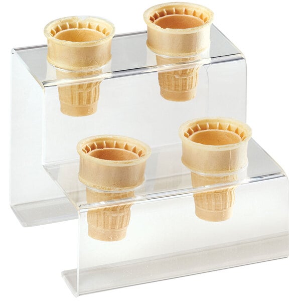 A clear display with four ice cream cones in it on a clear acrylic stand.
