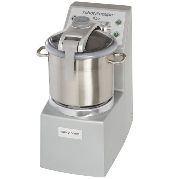 A Robot Coupe stainless steel food processor with a silver lid on a silver bowl.