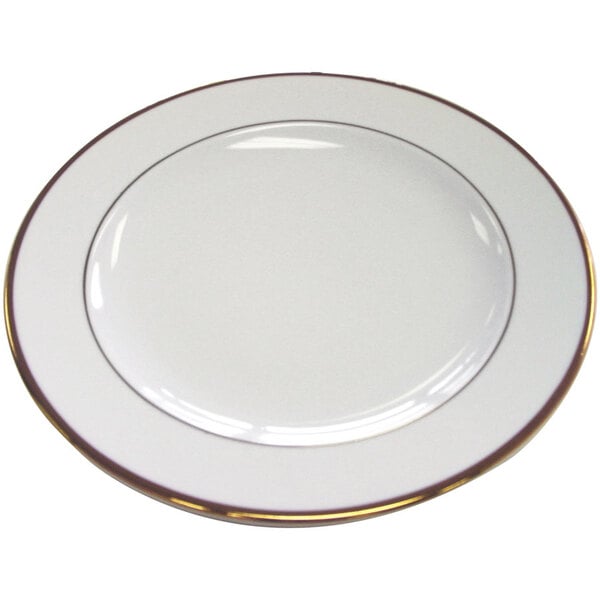 A CAC white porcelain plate with a gold rim.