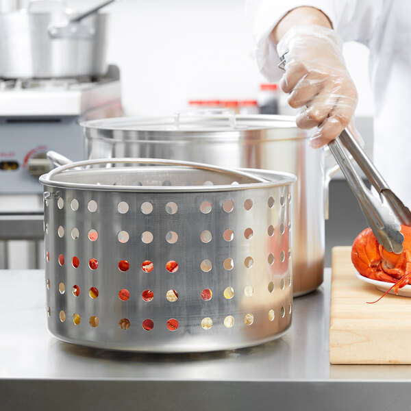 A Vollrath Wear-Ever fryer basket in a commercial kitchen.