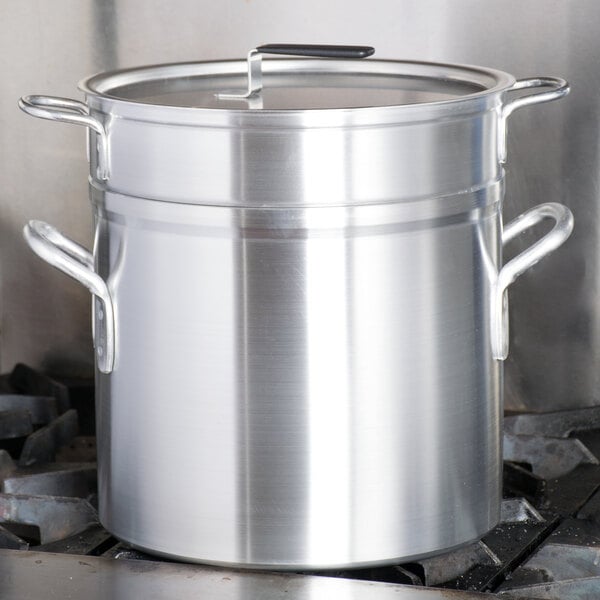 A Vollrath Wear-Ever aluminum double boiler set on a stove.