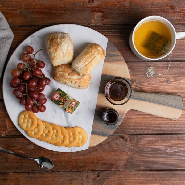 An Elite Global Solutions faux hickory and marble melamine serving board with a plate of food and a cup of tea on it.