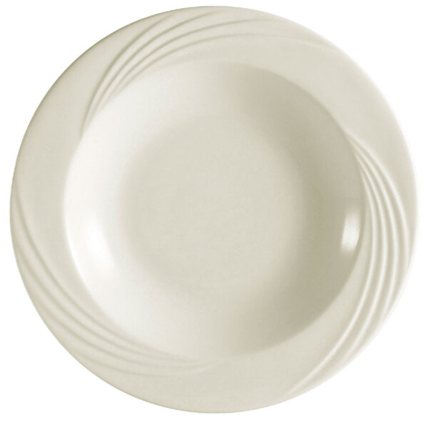 A white porcelain soup plate with a wavy design on the edge.