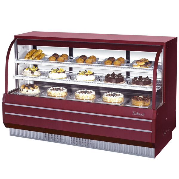 A red Turbo Air bakery display case with cakes and pastries.