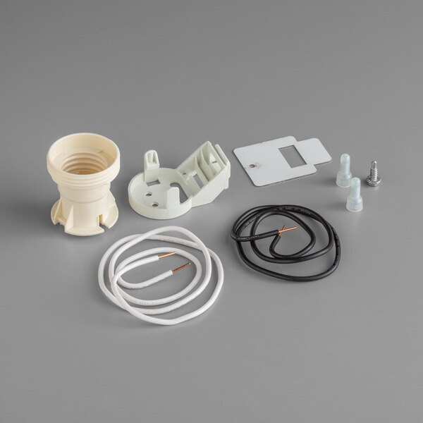 A white plastic True lamp socket replacement kit with a white cable and copper wire.