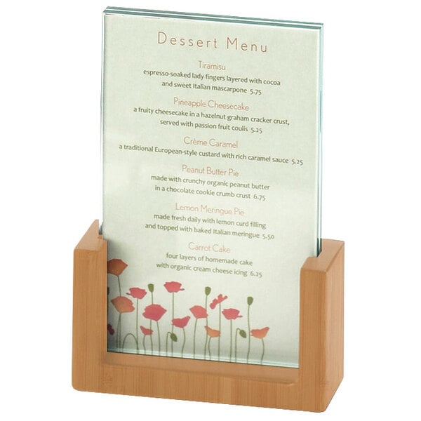 A Cal-Mil bamboo U-frame displayette holding a menu card on a table in a bakery display.