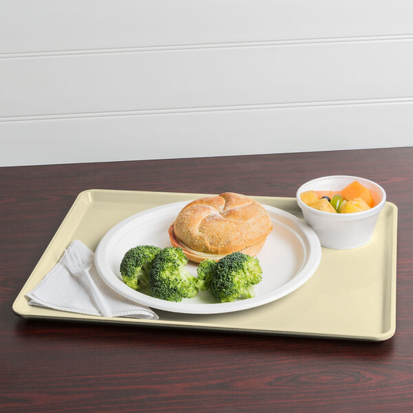A Cambro lemon chiffon dietary tray with food on it, including broccoli.