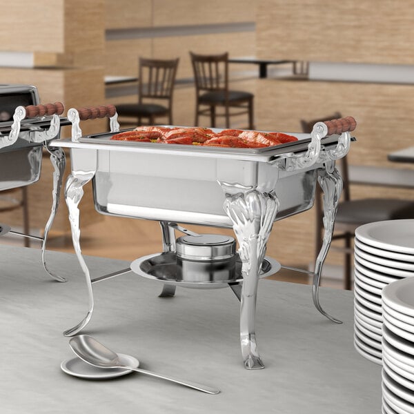 A buffet with white Choice Classic chafers and silverware on a table.