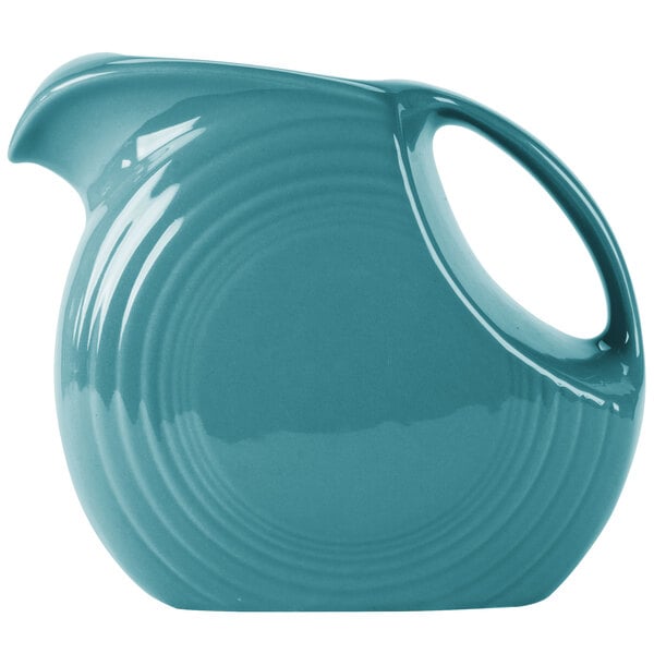 A turquoise Fiesta Disc China pitcher with a handle.