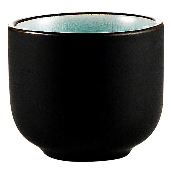 A black sake cup with a light blue rim.