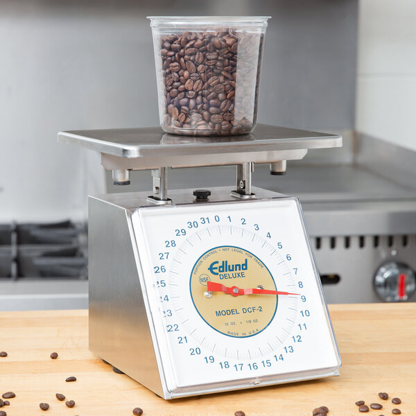 An Edlund Five Star portion scale with a container of coffee beans on it.