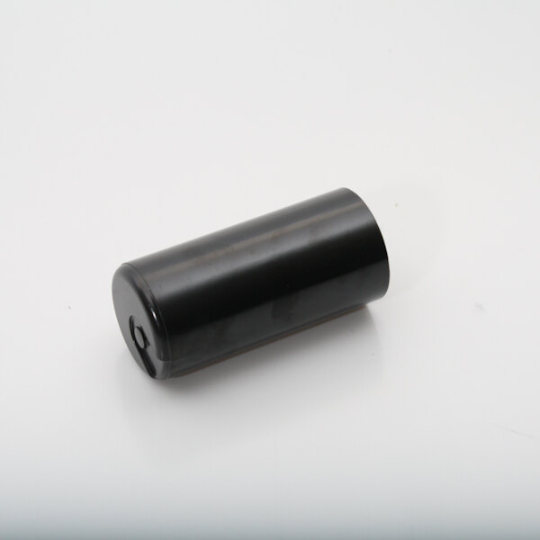 A black cylindrical Master-Bilt start capacitor.