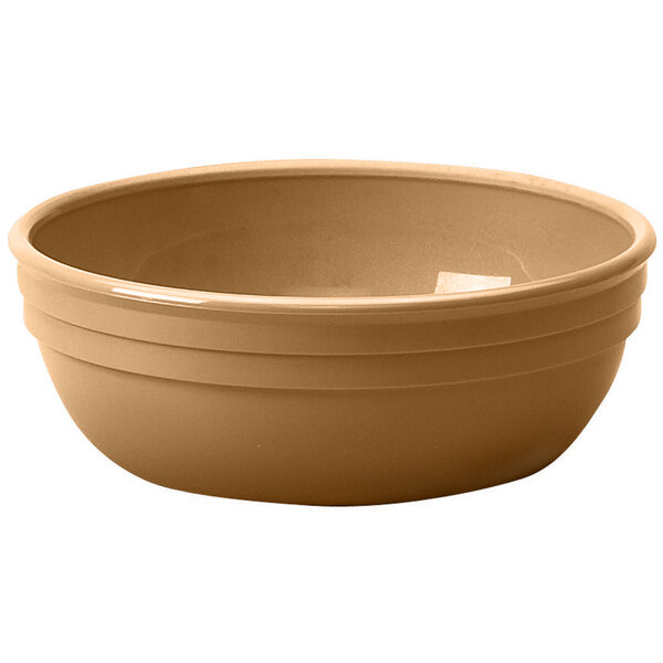 A beige Cambro polycarbonate bowl with a white surface.