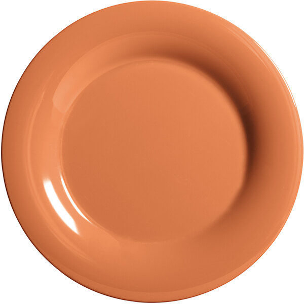 A close-up of a GET Pumpkin Diamond Harvest plate with a wide rim and a plain orange color.