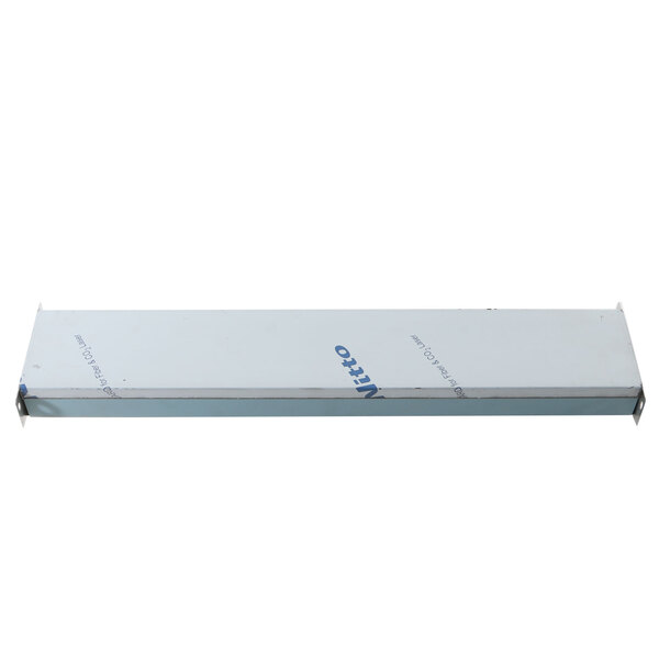 A white metal shelf with a white rectangular object with blue text on it.