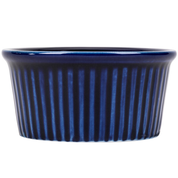 A close up of a blue CAC China fluted ramekin with stripes.