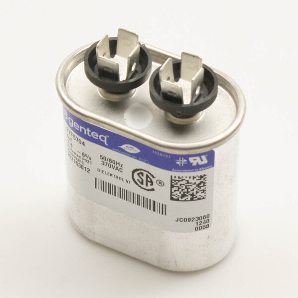 A Master-Bilt capacitor with black and silver plugs.