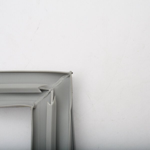 A close-up of a white plastic corner on a grey plastic ThermalRhite gasket frame.