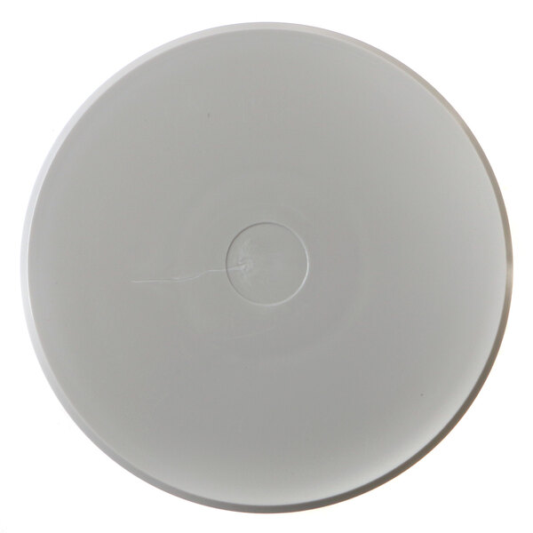A white circular cover with a hole in the middle.