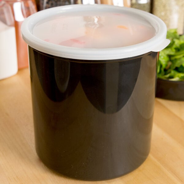 A black Cambro round crock with a white lid on a counter.