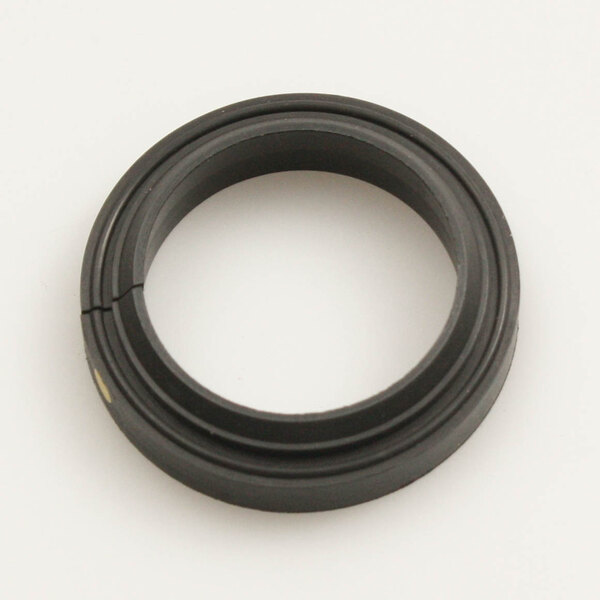 A black rubber ring with a yellow dot on it with a hole in the middle.