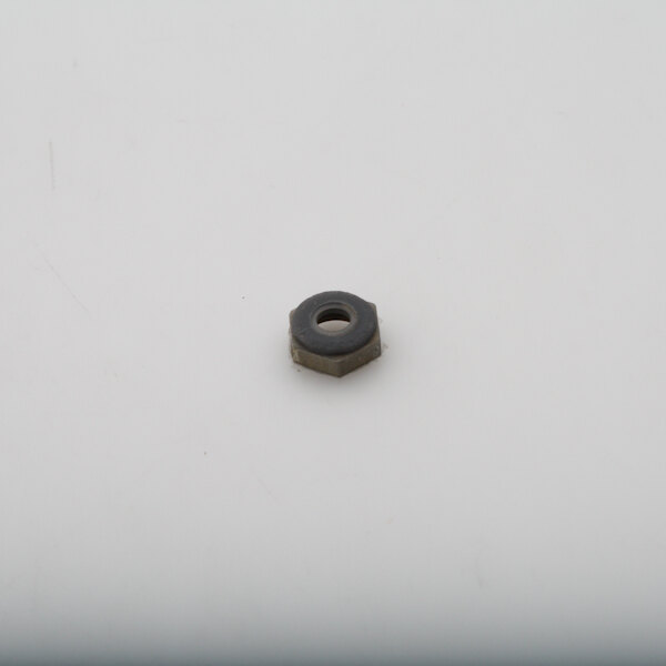 A small black nut on a white surface.