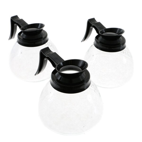 A group of three Bunn glass coffee pitchers with black plastic lids.