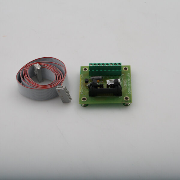 A green circuit board with a white and red cable and black connectors.